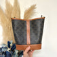 SMALL BUCKET IN TRIOMPHE CANVAS AND CALFSKIN